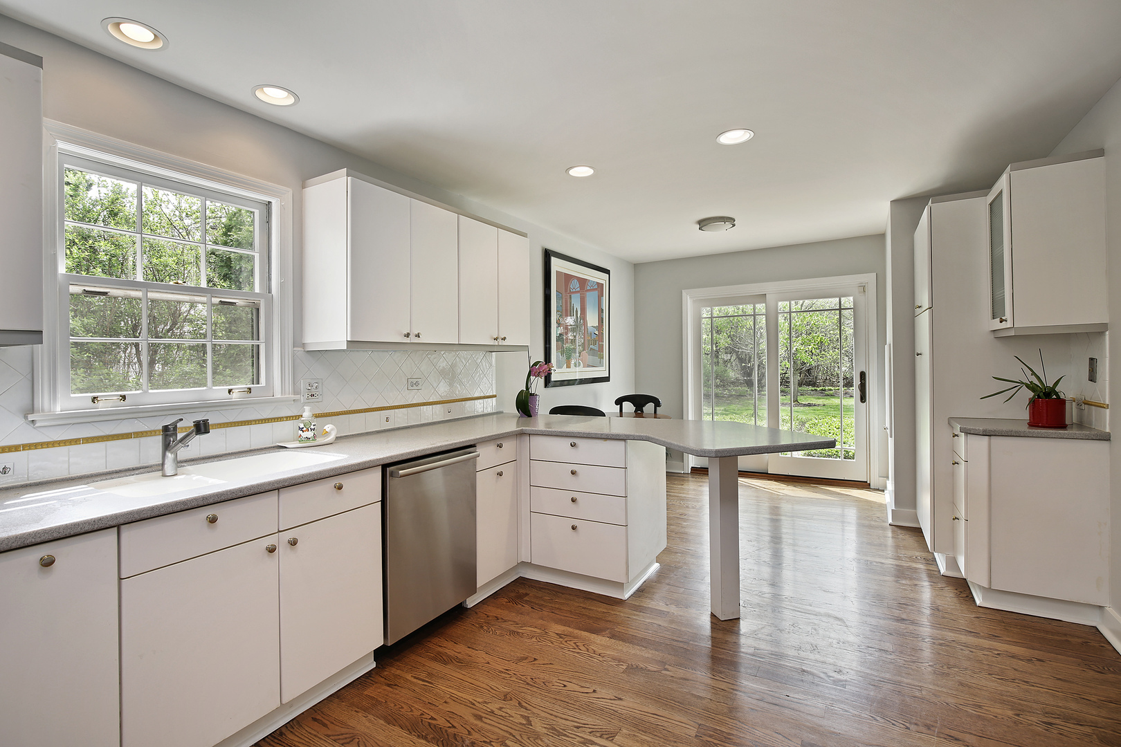 1115 West Deerpath Road Lake Forest, IL 60045 - Photo 3 of 18 a kitchen with a sink windows and cabinets
