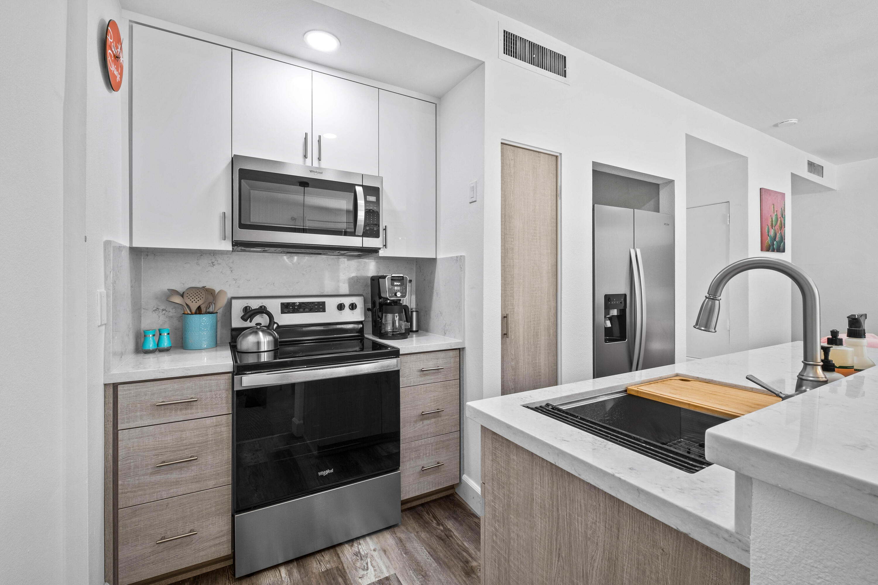 78130 Cortez Lane, Unit 56 Indian Wells, CA 92210 - Photo 5 of 31 a kitchen with stainless steel appliances granite countertop a stove a sink and a microwave