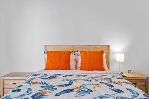 a bedroom with a bed and window