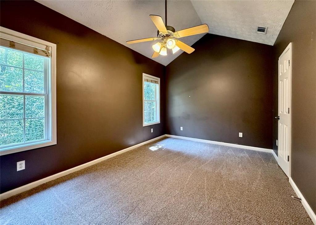 6258 Southern Magnolia Lane Lula, GA 30554 - Photo 11 of 17 an empty room with a window and a chandelier