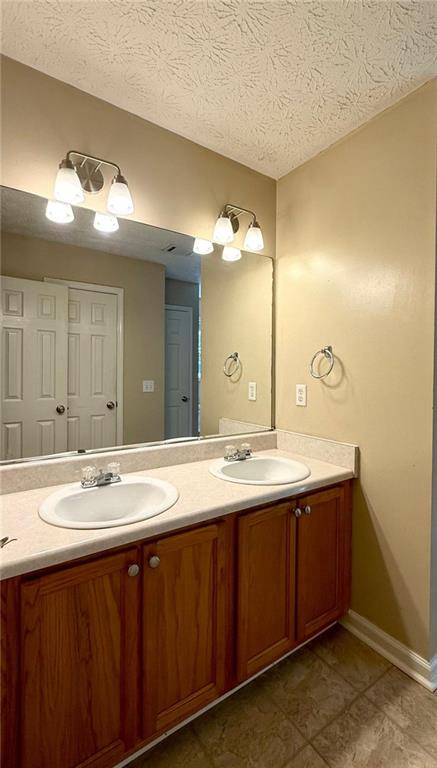 6258 Southern Magnolia Lane Lula, GA 30554 - Photo 12 of 17 a bathroom with a double vanity sink and a mirror
