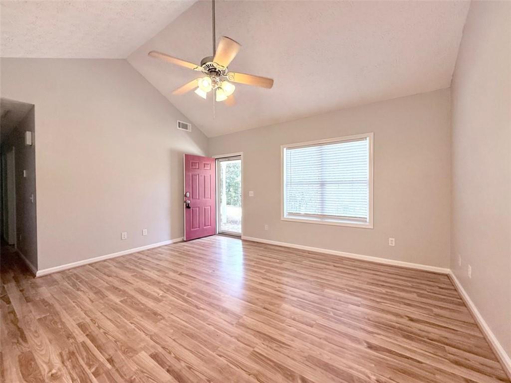6258 Southern Magnolia Lane Lula, GA 30554 - Photo 2 of 17 a view of an empty room with wooden floor and a window