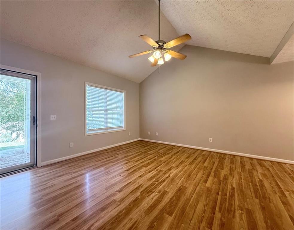6258 Southern Magnolia Lane Lula, GA 30554 - Photo 3 of 17 a view of an empty room with wooden floor and a window