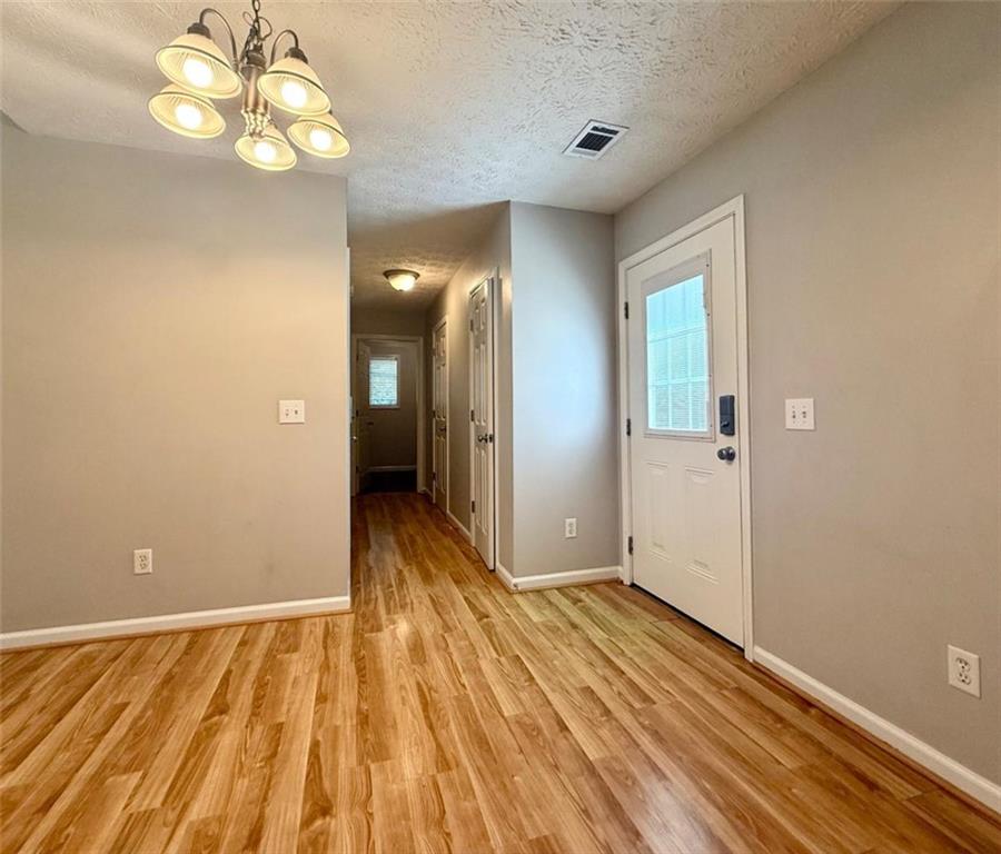 6258 Southern Magnolia Lane Lula, GA 30554 - Photo 6 of 17 wooden floor in an empty room with a mirror