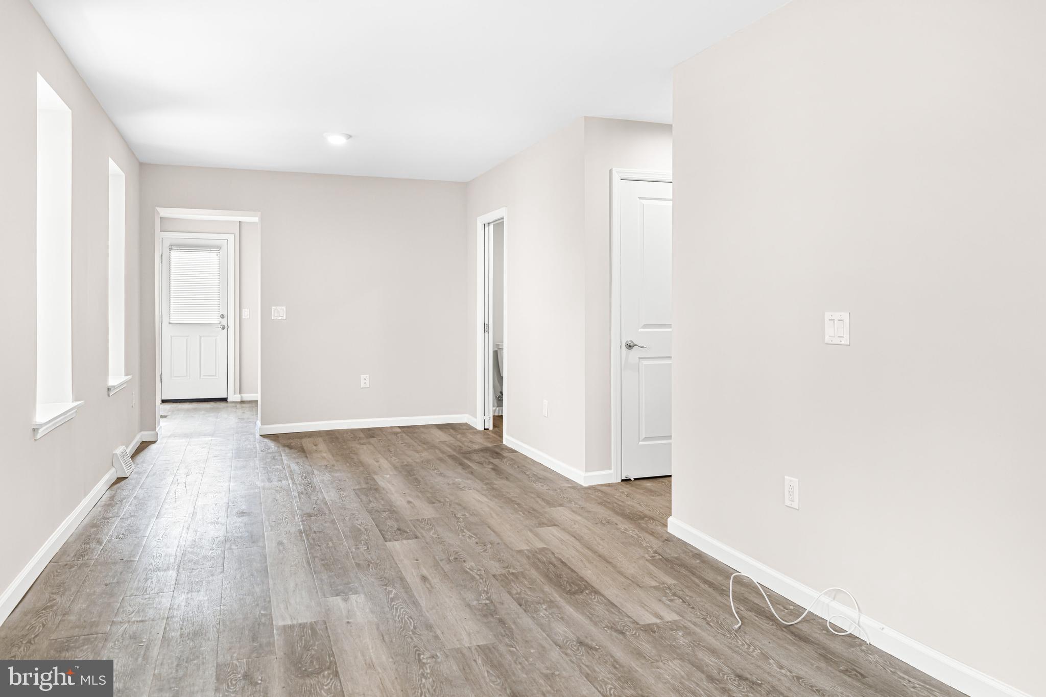 606 Summit Avenue Jenkintown, PA 19046 - Photo 10 of 27 an empty room with wooden floor and windows