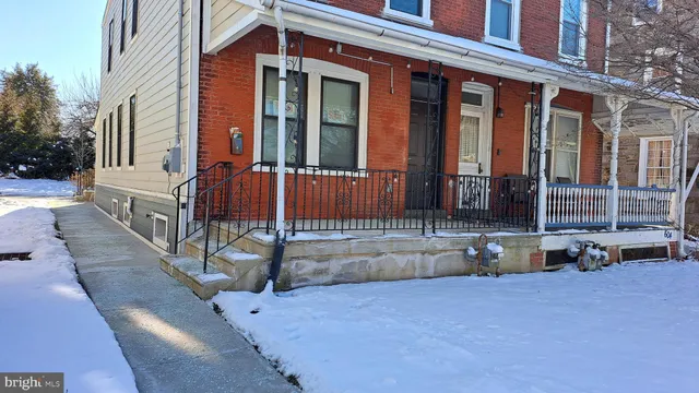 a view of hallway with wooden floor