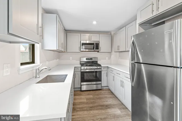 a kitchen with a refrigerator stove and sink