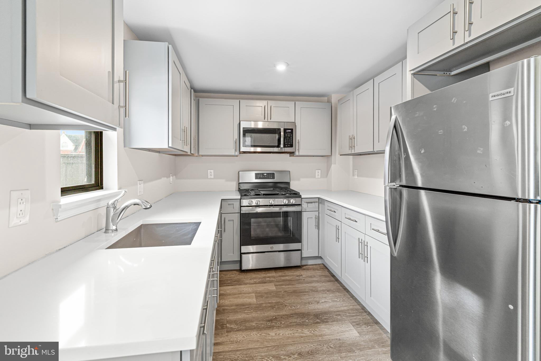 606 Summit Avenue Jenkintown, PA 19046 - Photo 6 of 27 a kitchen with a refrigerator stove and sink