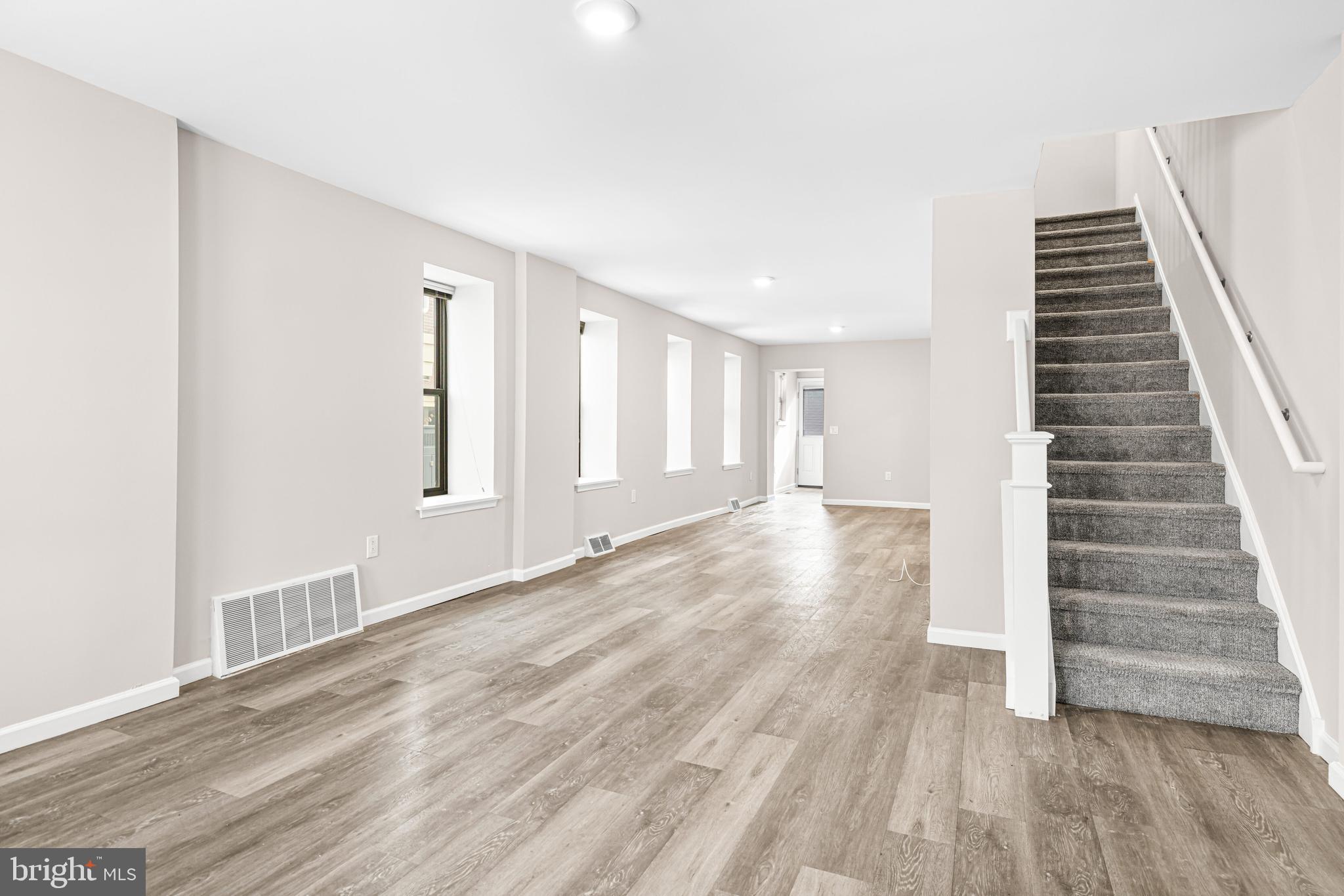 606 Summit Avenue Jenkintown, PA 19046 - Photo 9 of 27 a view of an empty room with wooden floor and stairs