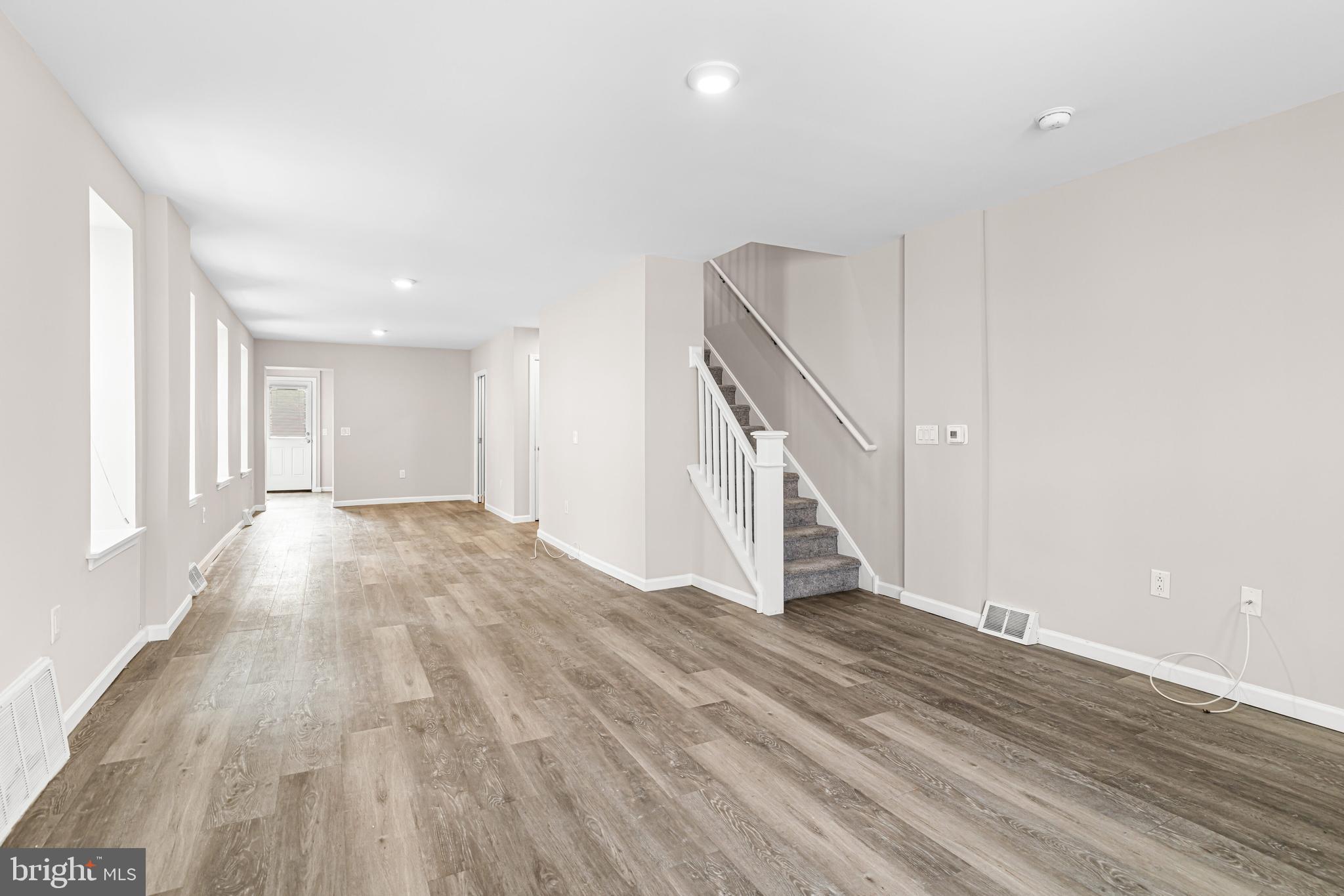 606 Summit Avenue Jenkintown, PA 19046 - Photo 26 of 27 a view of an empty room with wooden floor and stairs