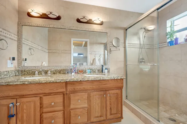 a bathroom with a granite countertop sink a toilet and a mirror