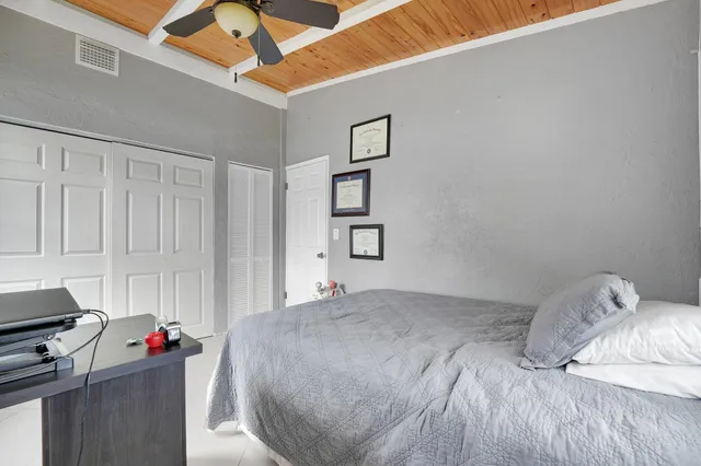 a bedroom with a bed and a desk