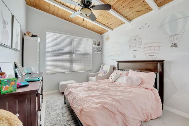 a view of a patio with table and chairs potted plants and a large tree