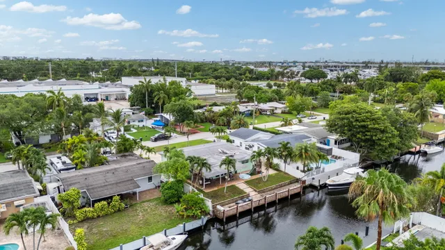 an aerial view of residential houses with outdoor space and river