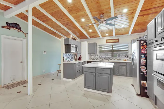 a kitchen with a sink appliances and cabinets