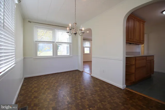 an empty room with windows and entrance