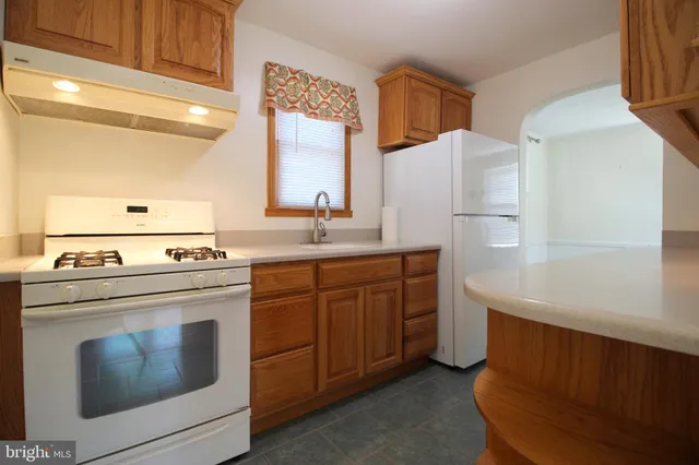 a kitchen with appliances cabinets and a sink
