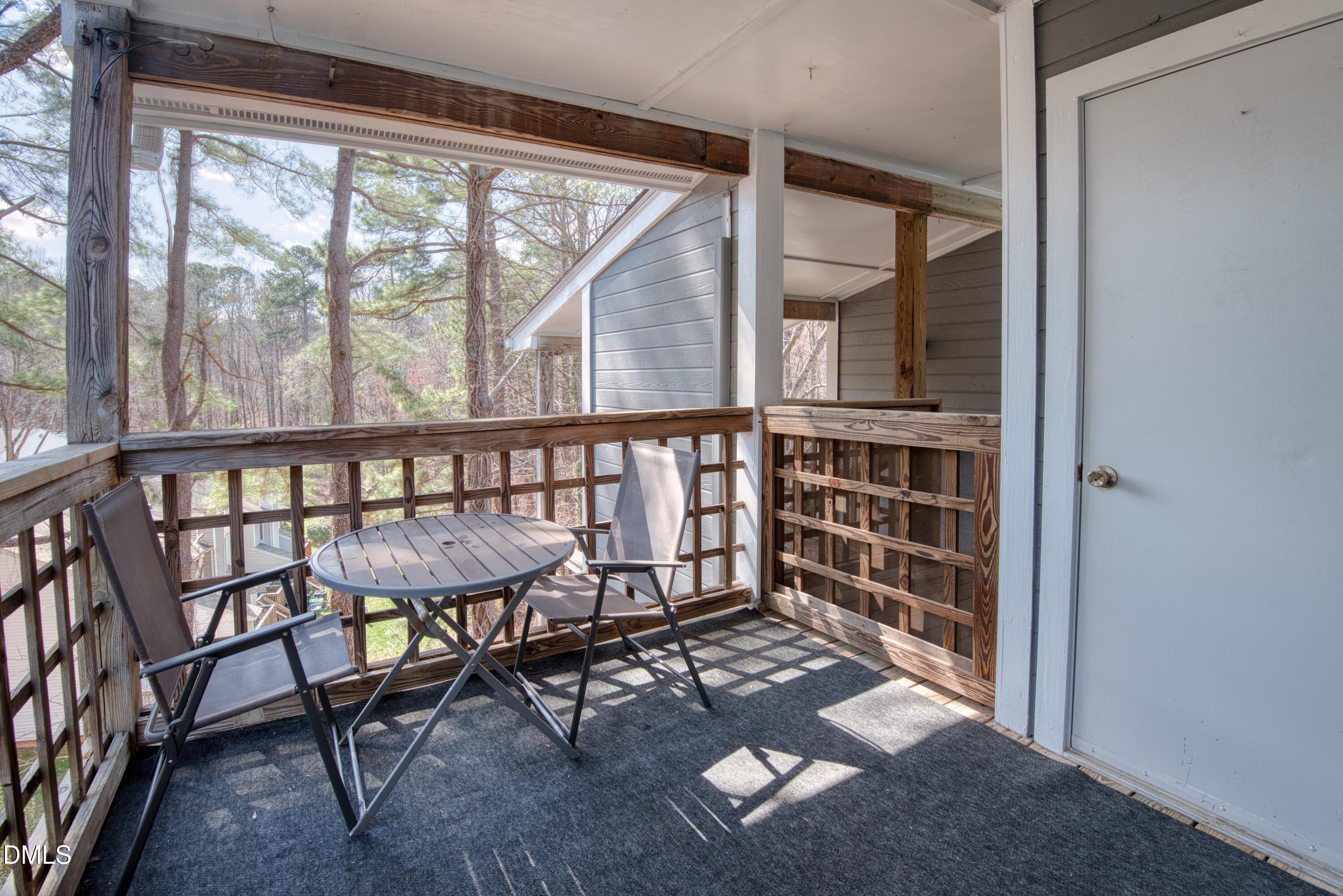 4641 Timbermill Court, Unit 302 Raleigh, NC 27612 - Photo 20 of 27 a view of a porch with chairs and backyard