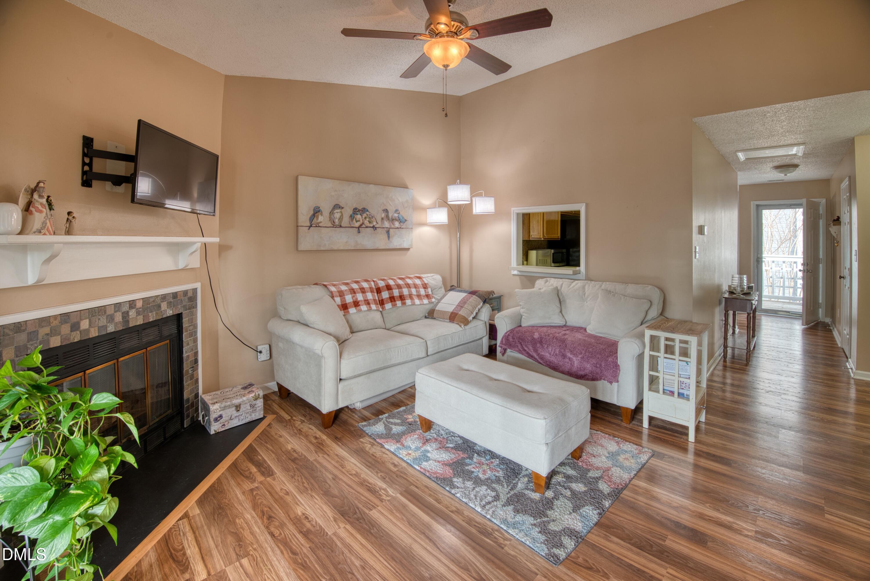 4641 Timbermill Court, Unit 302 Raleigh, NC 27612 - Photo 3 of 27 a living room with furniture and a fireplace