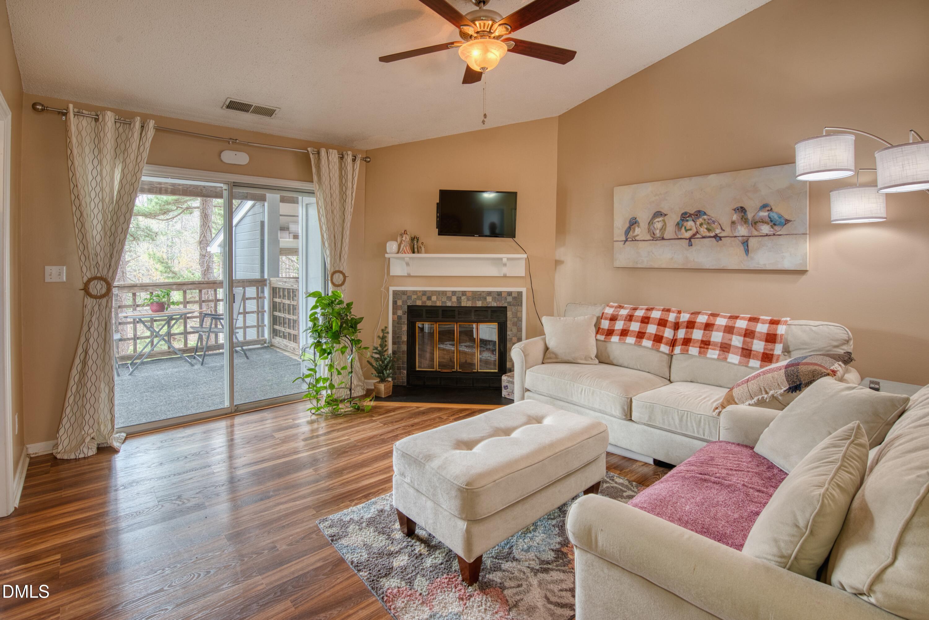 4641 Timbermill Court, Unit 302 Raleigh, NC 27612 - Photo 5 of 27 a living room with furniture fireplace and window