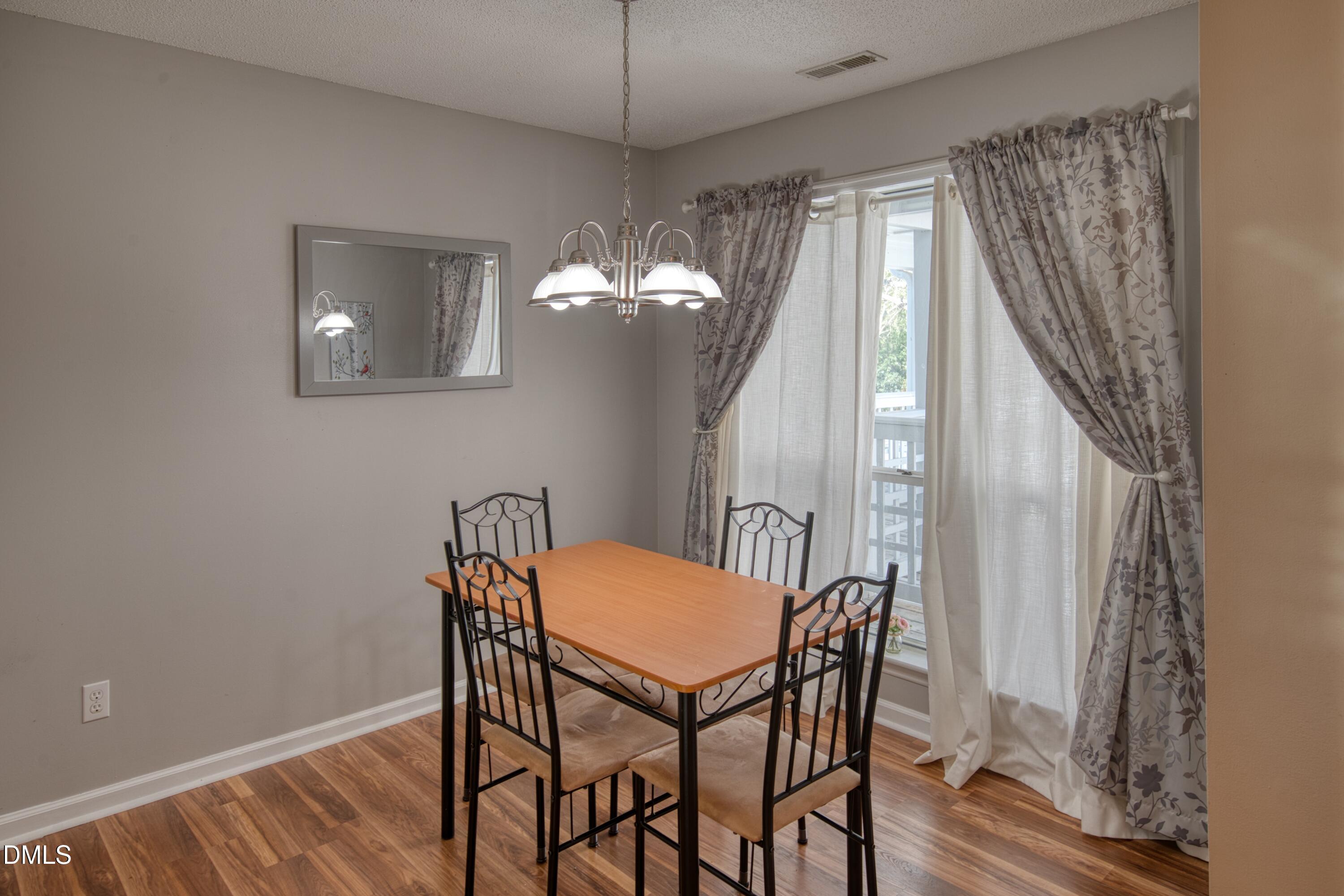 4641 Timbermill Court, Unit 302 Raleigh, NC 27612 - Photo 7 of 27 a view of a dining room with furniture and window