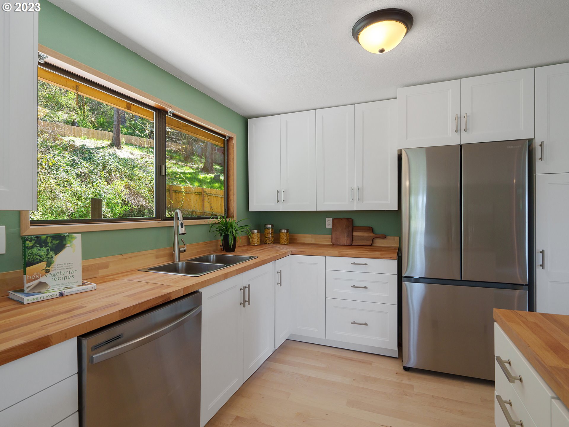 1009 South 70th Street Springfield, OR 97478 - Photo 15 of 48 a kitchen with a sink refrigerator and window