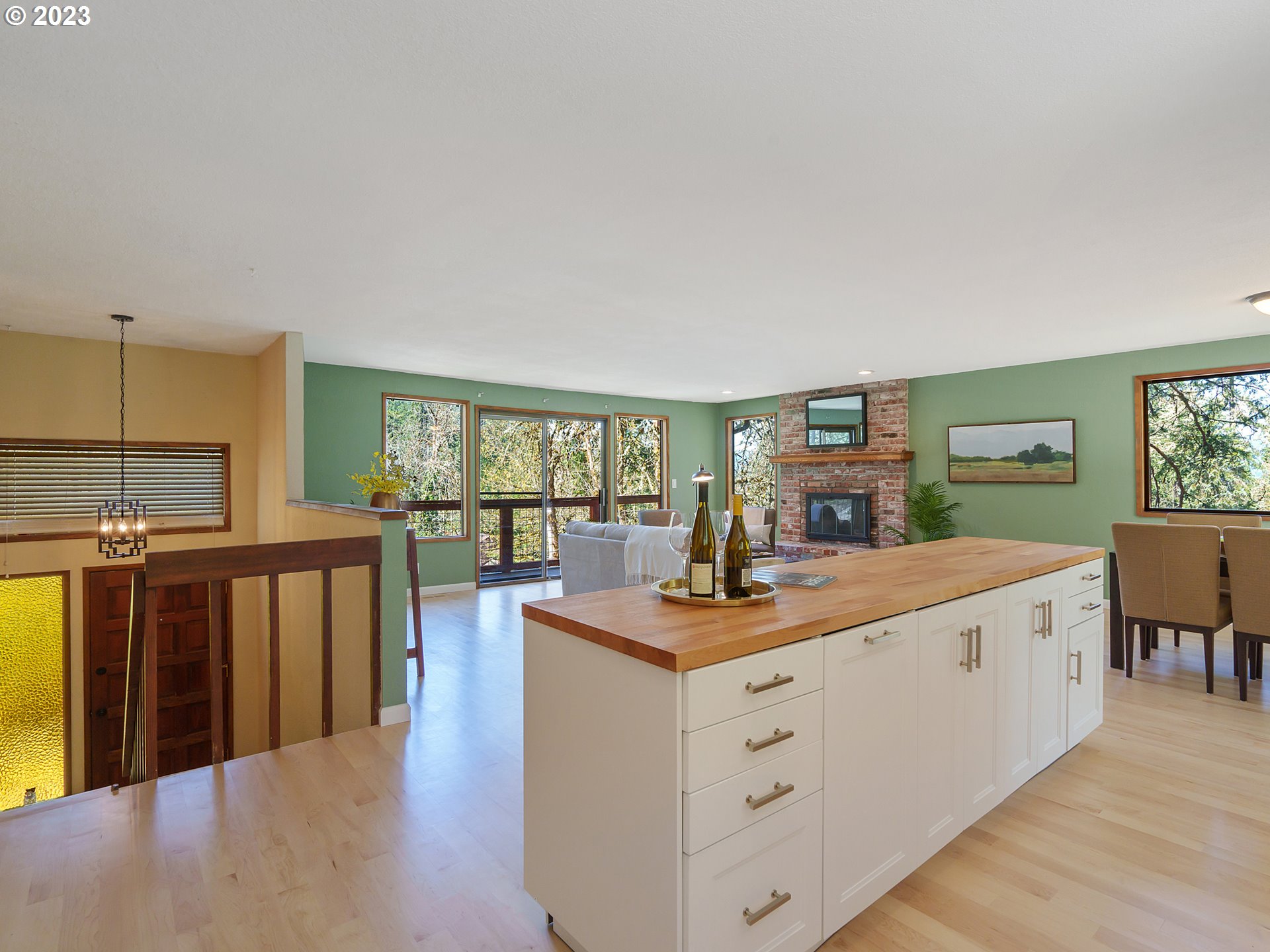 1009 South 70th Street Springfield, OR 97478 - Photo 18 of 48 a living room with furniture a flat screen tv and a floor to ceiling window
