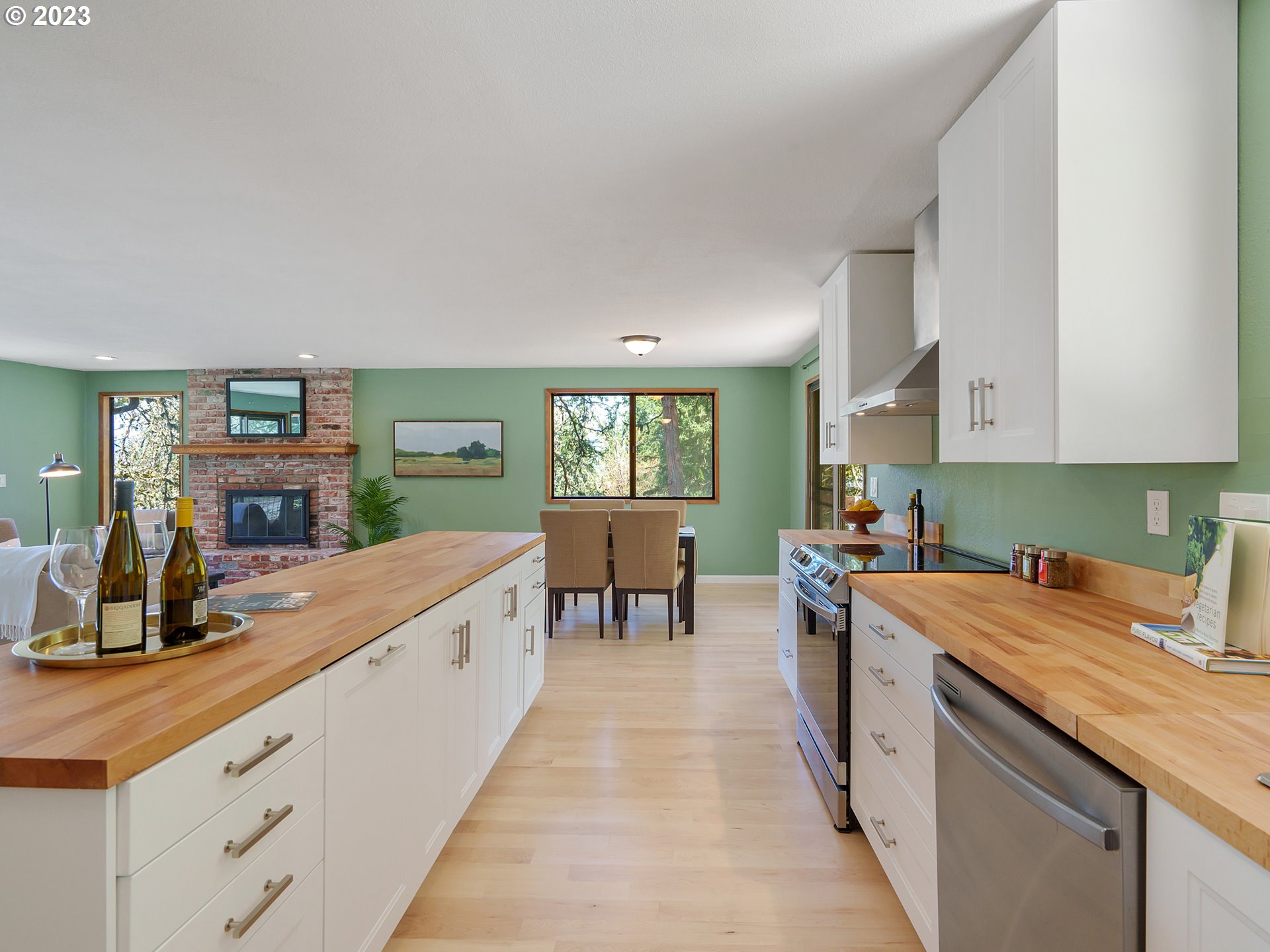 1009 South 70th Street Springfield, OR 97478 - Photo 20 of 48 a kitchen with stove a sink and white cabinets with wooden floor