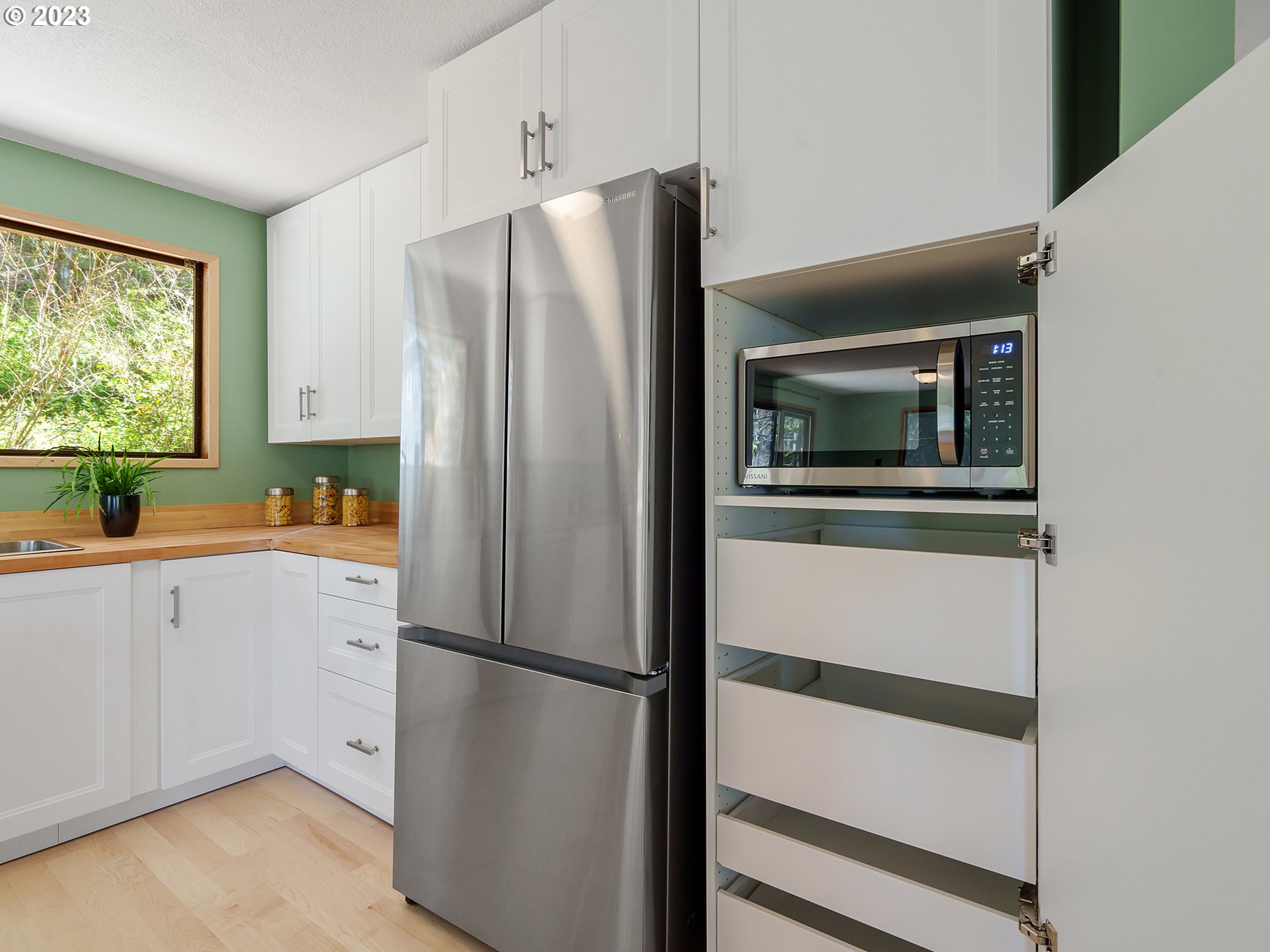 1009 South 70th Street Springfield, OR 97478 - Photo 21 of 48 a white refrigerator freezer sitting inside of a kitchen