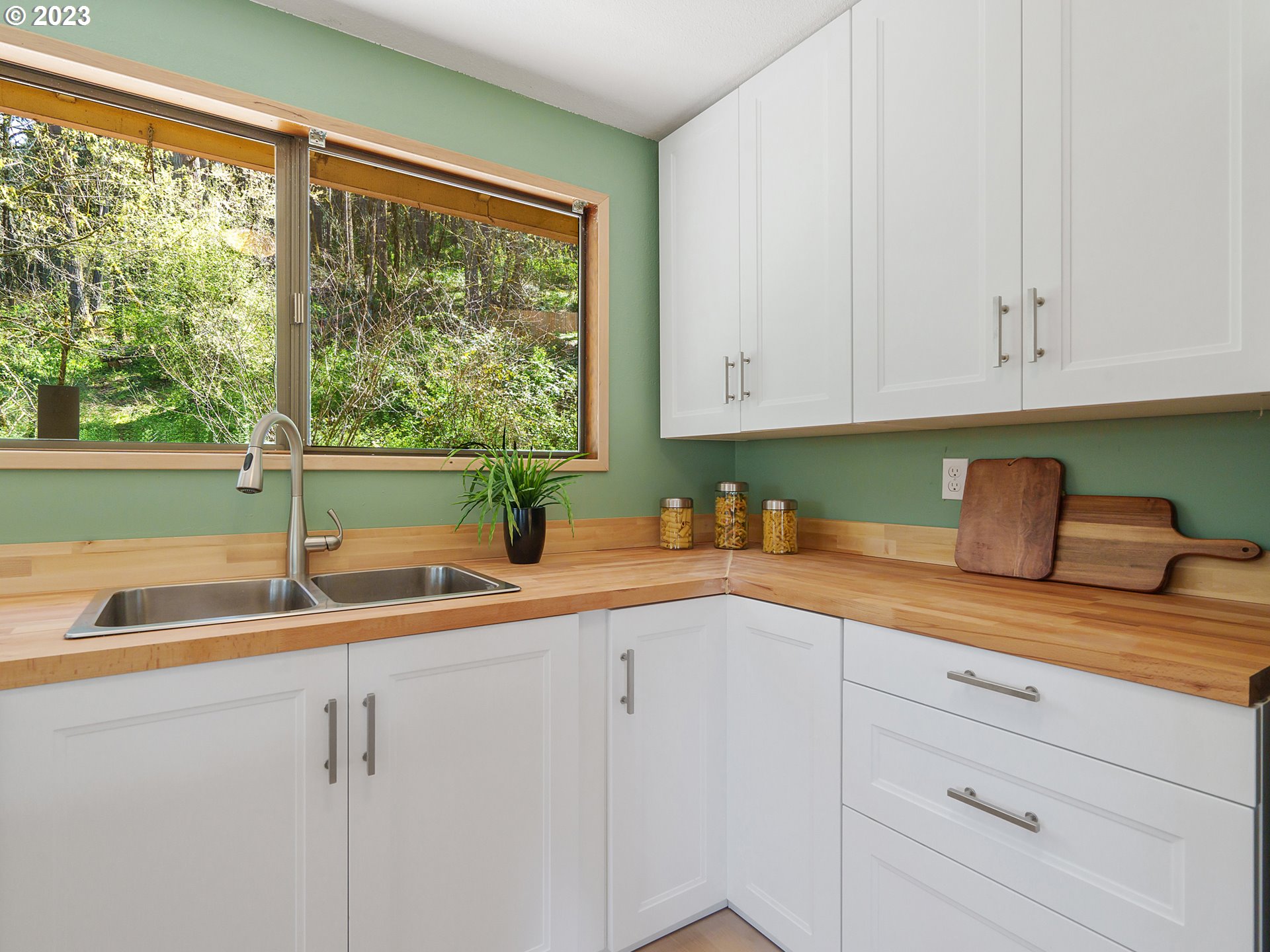 1009 South 70th Street Springfield, OR 97478 - Photo 22 of 48 a kitchen with granite countertop white cabinets and a sink