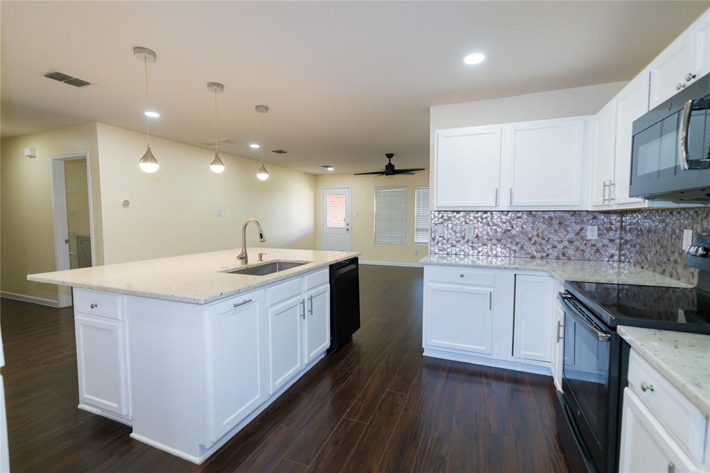 1717 Shawnee Trail Allen, TX 75002 - Photo 14 of 35 a kitchen with a sink stove and cabinets