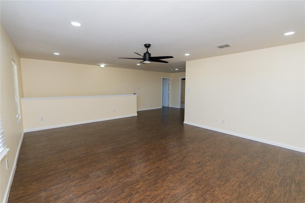 1717 Shawnee Trail Allen, TX 75002 - Photo 22 of 35 an empty room with wooden floor and a ceiling fan