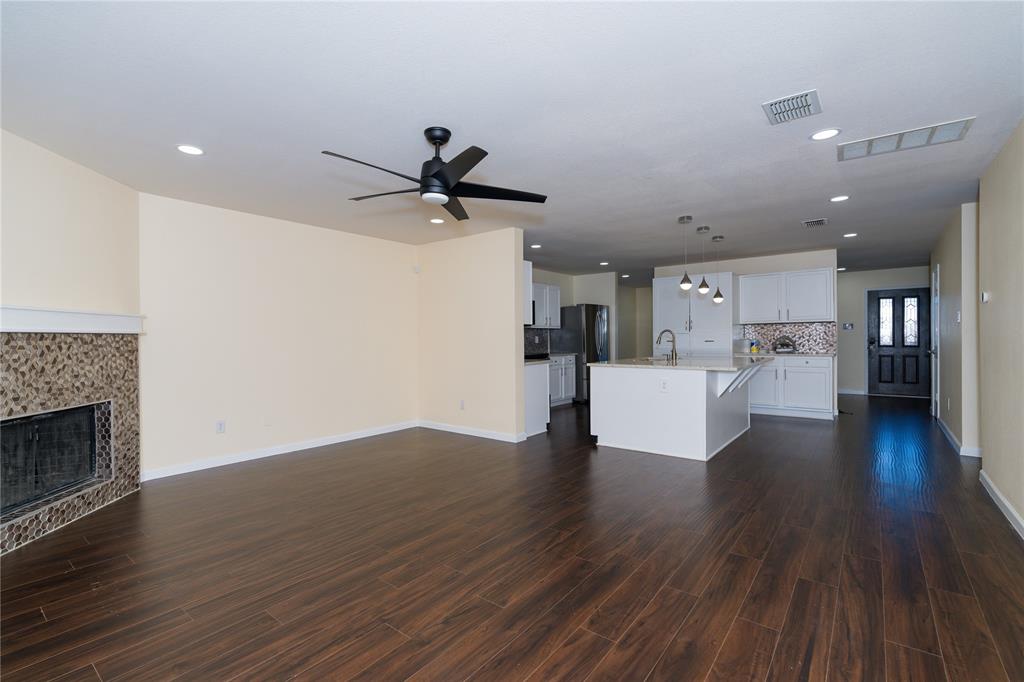 1717 Shawnee Trail Allen, TX 75002 - Photo 27 of 35 a view of a living room a kitchen and a wooden floor
