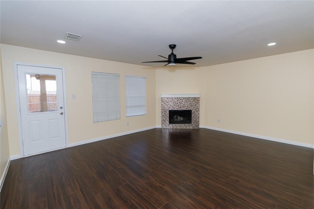 1717 Shawnee Trail Allen, TX 75002 - Photo 31 of 35 a view of an empty room with wooden floor and a fireplace