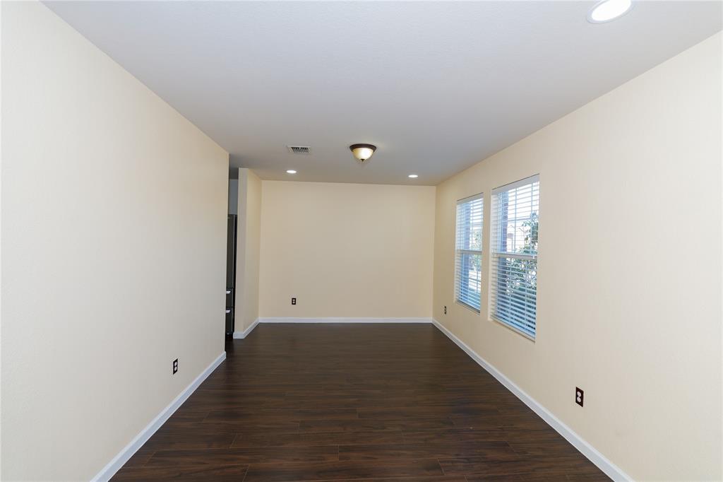 1717 Shawnee Trail Allen, TX 75002 - Photo 33 of 35 a view of an empty room with wooden floor and a window