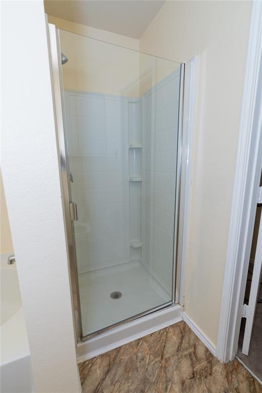 1717 Shawnee Trail Allen, TX 75002 - Photo 5 of 35 a bathroom with a glass shower door