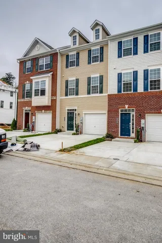 a front view of a residential apartment building with a yard