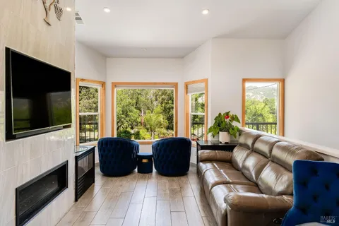 a kitchen with stainless steel appliances kitchen island granite countertop a table chairs and a refrigerator