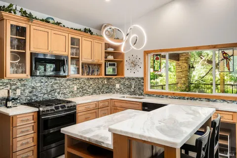 a living room with patio furniture and garden view
