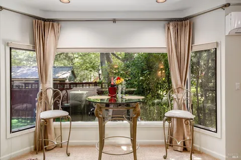 a backyard of a house with table and chairs