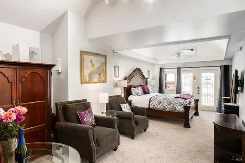 a bathroom with a granite countertop sink toilet a mirror and window