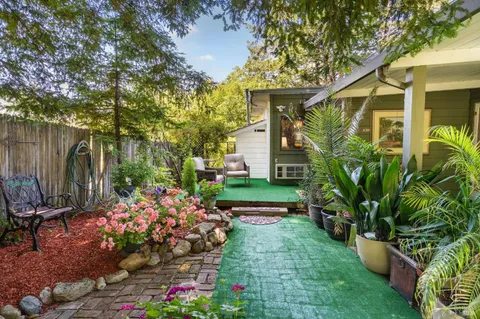 a living room with furniture a ceiling fan and a window