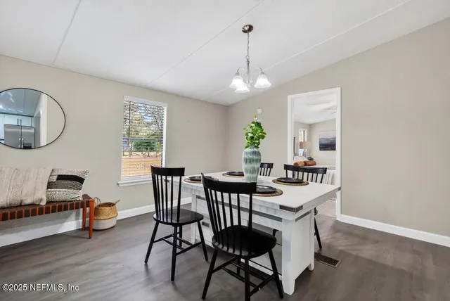 a living room with granite countertop kitchen island furniture and a wooden floor