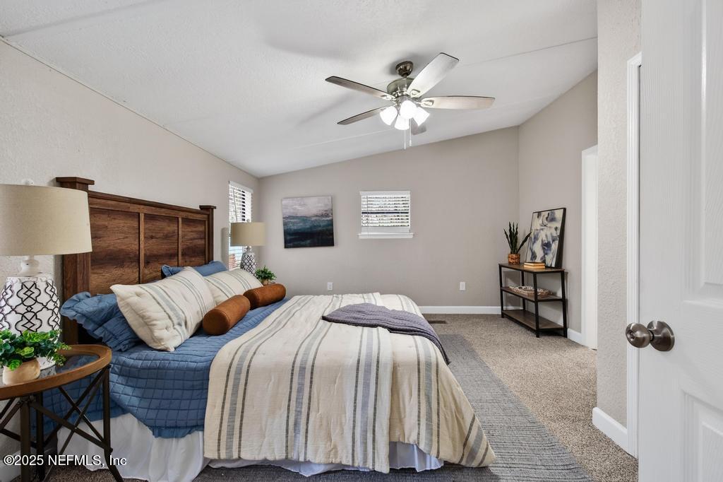 95422 Plum Loop Fernandina Beach, FL 32034 - Photo 36 of 76 a bedroom with a bed and a walk in closet