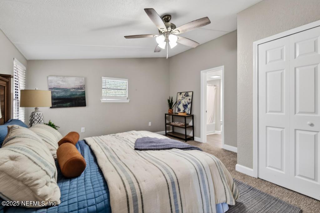 95422 Plum Loop Fernandina Beach, FL 32034 - Photo 37 of 76 a bedroom with a bed and a chandelier