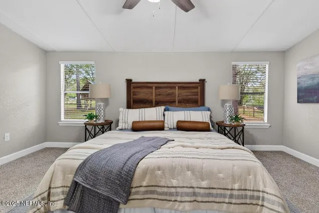 a view of a house with backyard and trees