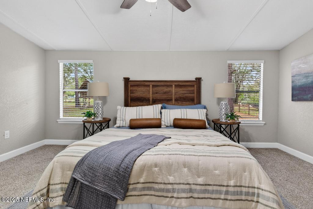 95422 Plum Loop Fernandina Beach, FL 32034 - Photo 40 of 76 a bedroom with a large bed and a large window