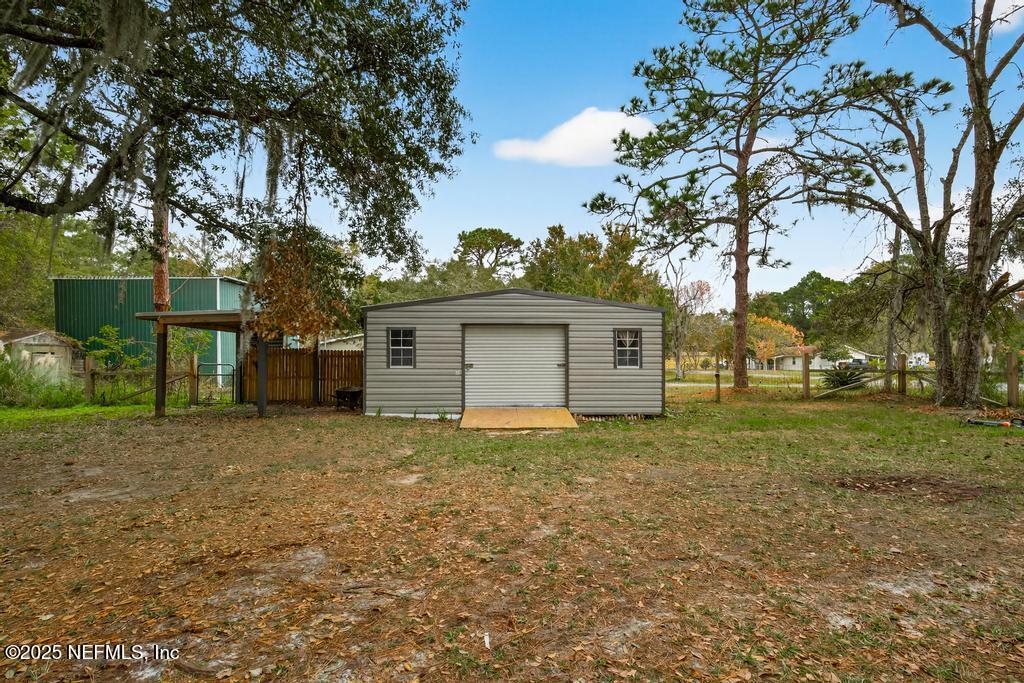95422 Plum Loop Fernandina Beach, FL 32034 - Photo 60 of 76 a view of a house with a yard and large trees