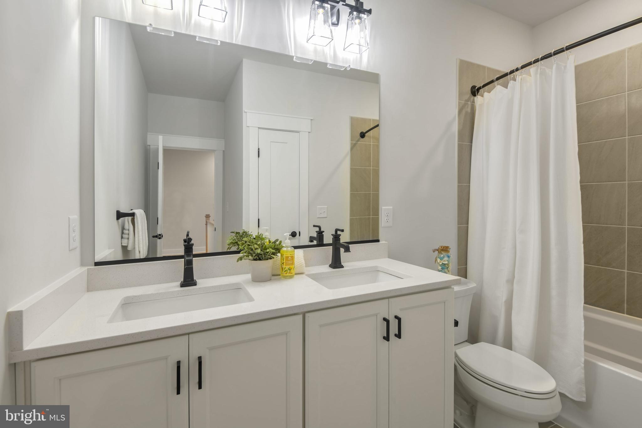 Eliana Court Laurel, MD 20708 - Photo 33 of 46 a bathroom with a sink a toilet and shower