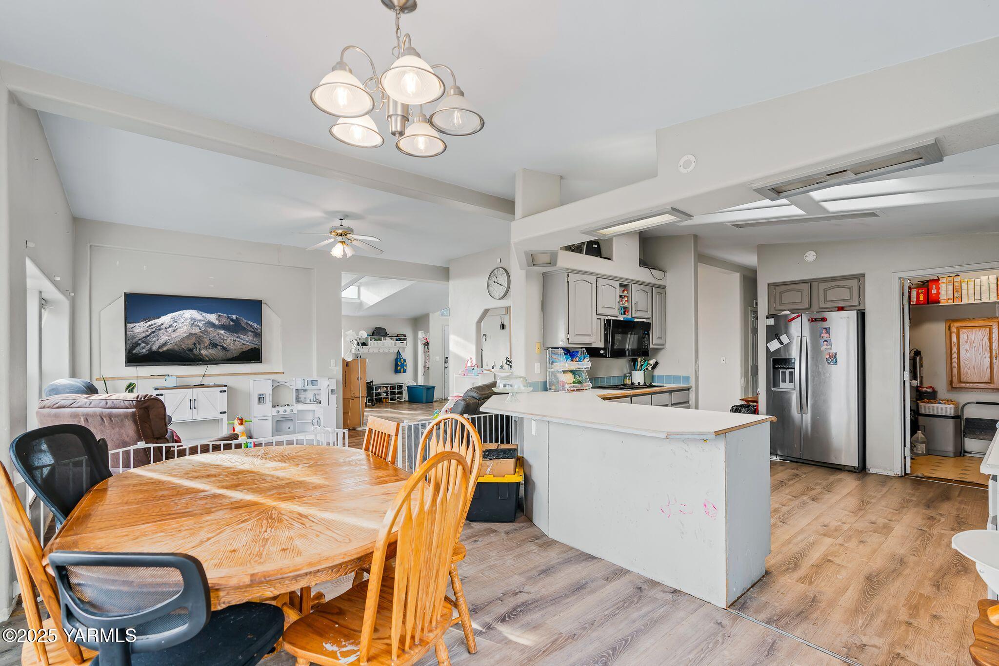 1880 Franklin Road Tieton, WA 98947 - Photo 4 of 29 a dining room with wooden floor and stainless steel appliances